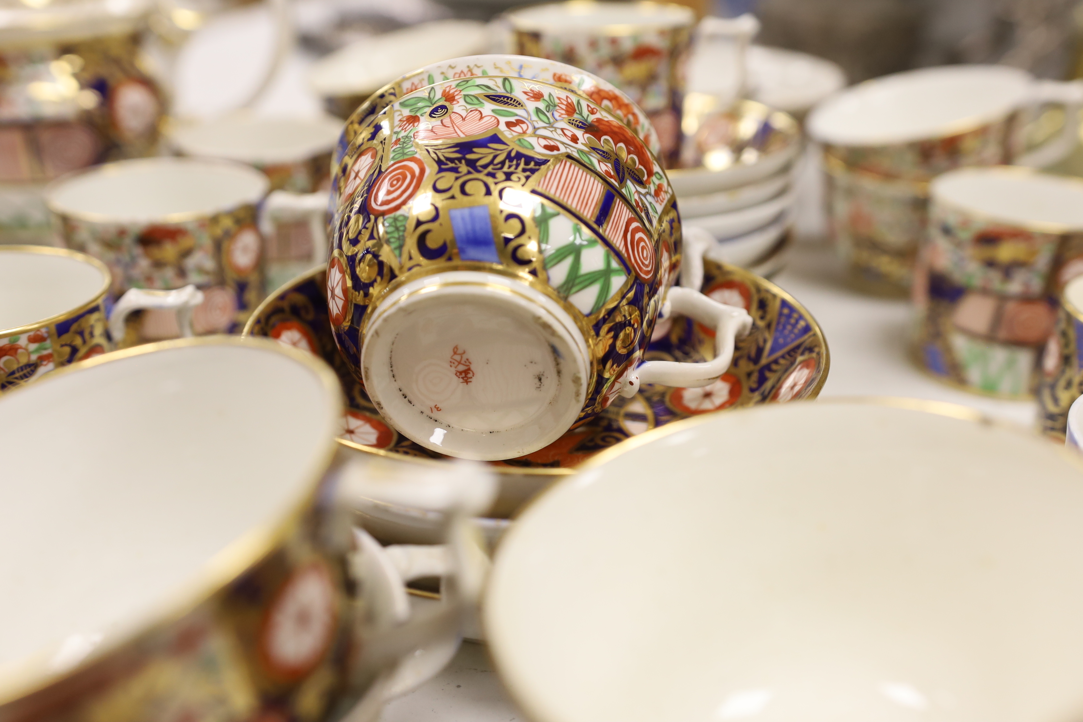 An early 19th century Derby Japan pattern part tea and coffee set, including cups and saucers, teapot, milk jug and bowl